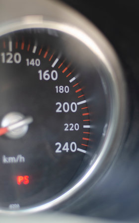 Speedometer with the 200 km per hour sign in the foreground. car speed