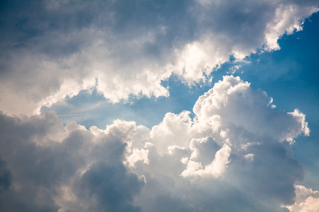 Dramatic Clouds after a thunder storm illuminated by bright sunlight
