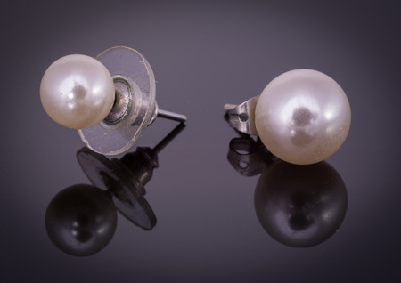 Earrings with ball shape on black backgroundの写真素材