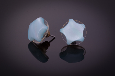 Earrings with star shape on black backgroundの写真素材