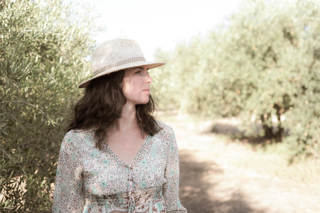 Portrait of a beautiful woman in a straw hat on a sunny dayの写真素材