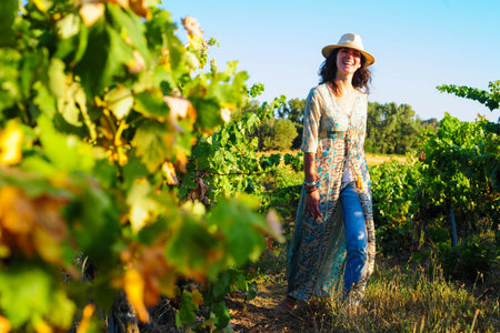 Portrait of a beautiful young woman with hat in the vineyardの写真素材