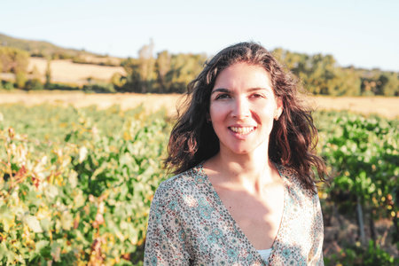 Portrait of a beautiful young woman with hat in the vineyardの写真素材