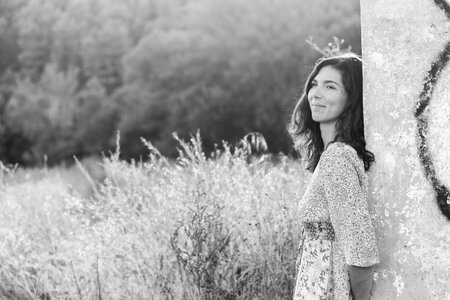Portrait of a beautiful young woman smiling in a natural setting.の写真素材