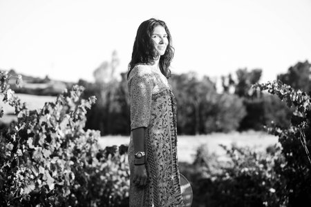 Portrait of a beautiful young woman with hat in the vineyardの写真素材