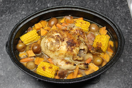 Roasted chicken and vegetables in a roasting pan.の写真素材