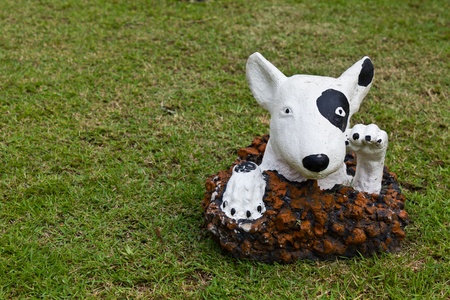 statue of a dog decorated on the lawnの写真素材