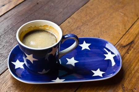 Cup of coffee and  saucer on a wooden floorの写真素材