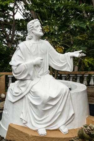 White Jesus statue in front of churchの写真素材