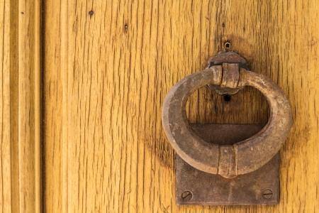 Door knock on a yellow wooden doorの写真素材