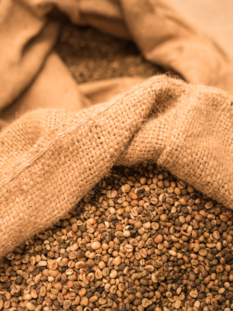 green unroasted coffee beans in sack.の写真素材