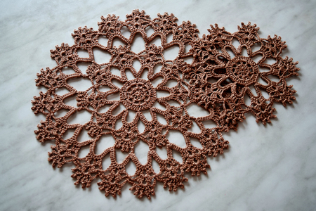 Brown hand hooked coaster. Set of supports for hot dishes