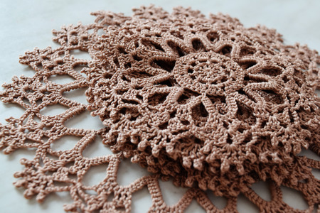 Brown hand hooked coaster. Set of supports for hot dishesの写真素材