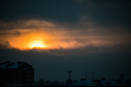 Sunset over the city. Colorful sunset with clouds over the city.の写真素材