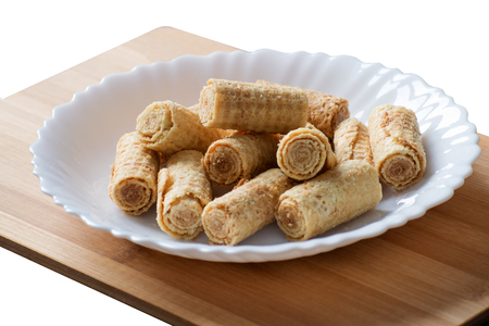 Rolled viennese waffles on white plate. Crispy waffles rollsの写真素材