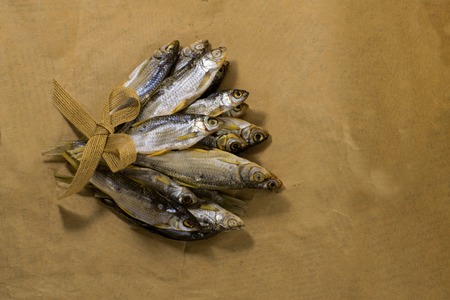 Sun dried fish. Fish on the brown craft paper. Bleak.の写真素材