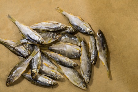 Sun dried fish. Fish on the brown craft paper. Bleak.の写真素材