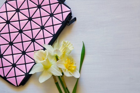 Cosmetic bag and flowers on white backgroundの写真素材