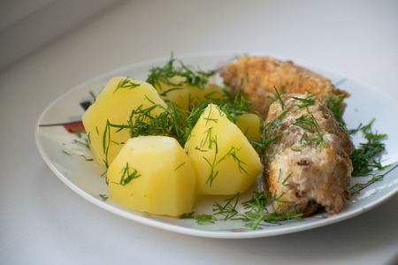 Slices of grilled sea bass with boiled potatoes.の写真素材