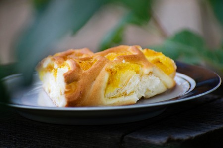 Delicious cake with apricot jam on a plate. Crostata with marmalade or peach jam filling.