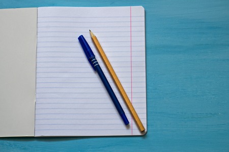 Top view of blank paper with pencil and pen. Pencil and pen on a notebook sheet.の写真素材