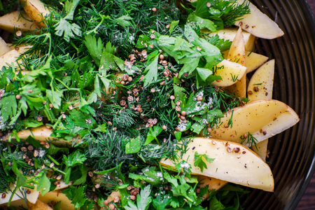 Process of cooking baked potatoes. Potato with chili, garlic and spices.の写真素材