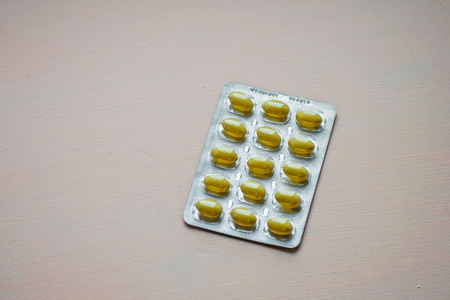 Closed up yellow tablet in blister pack. Pharmaceutical and health care concept.の写真素材