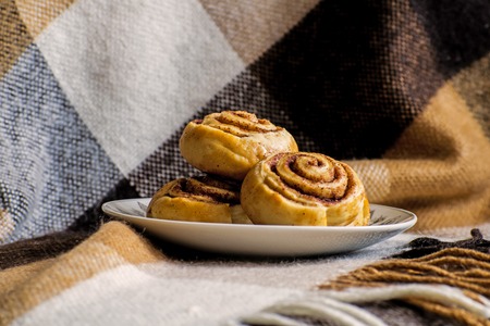 Sweet cinnamon rolls buns with spices and cocoa. Christmas baking pastry.の写真素材