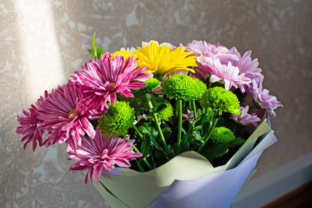 Bright bouquet with pink, crimson, green chrysanthemums with a yellow gerberaの写真素材