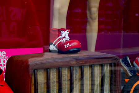 Crete, Greece, June 29, 2015: red stylish youth boots in a shop windowのeditorial素材