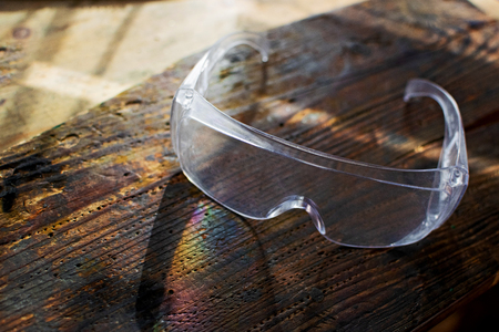 Craftsman tool for man worker. Glasses safety on a wooden workbench.の写真素材