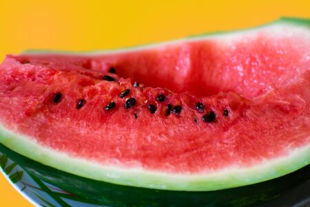 Beautiful fresh red watermelon on bright yellow background.の写真素材