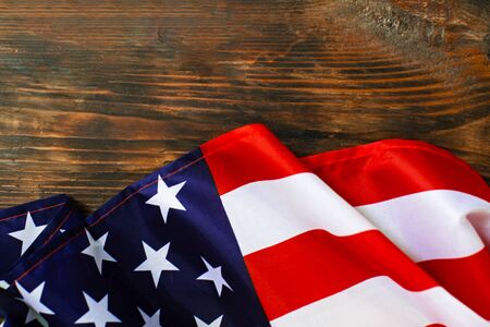 Closeup of American flag on a old wooden background.