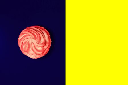 Beautiful hoemade strawberry cupcake with butter cream on yellow and classic blue background.の写真素材
