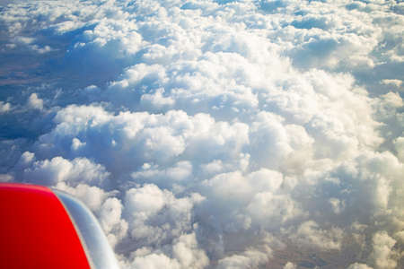 Wonderful view of the clouds from the airplane window. Fluffy clouds in sunbeams.の写真素材
