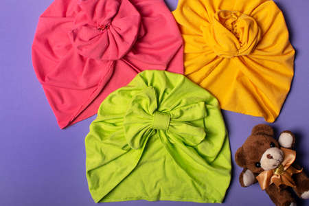 Three cute children headband or turban on violet background.の写真素材