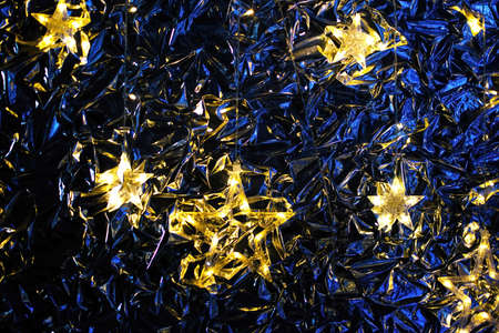Golden twinkling stars on classic blue background. Sparkling Christmas and New Year background.の写真素材