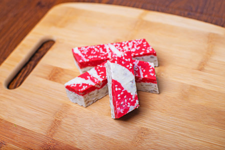 Hazelnut halva dessert with pomegranate juice on the wooden board.