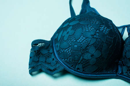 Beautiful green bra. Navy lace lingerie on a green background.の写真素材