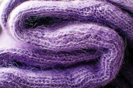 Texture of violet wool knitted as background. Knitted woolen sweater. Color 2022.の写真素材