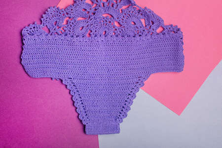 Lilac knitted swimsuit made of natural fabrics. Summer vacation concept. Handmade.の写真素材