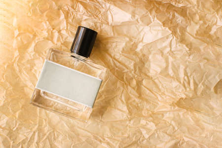 Close-up of glass bottle of perfume on craft paper.の写真素材