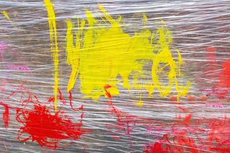 Idea for a game with a child: children's drawing with paints on polyethylene. colorful background.の写真素材