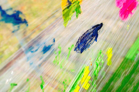 Idea for a game with a child: children's drawing with paints on polyethylene. colorful background.の写真素材
