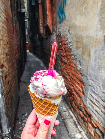 Charm of Venice, narrow canals, oclose view of ice cream