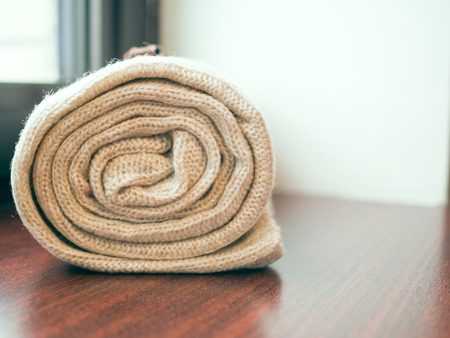 Background of warm twisted thick blankets. Stack of woolen checked blankets. The cosiness and...