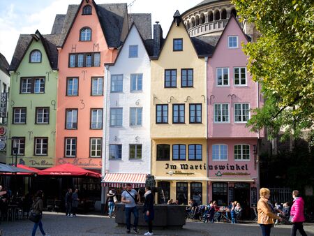 Germany, Cologne - October 2018. Sunny street, multicolored buildings, cozy cafes, city lifeのeditorial素材