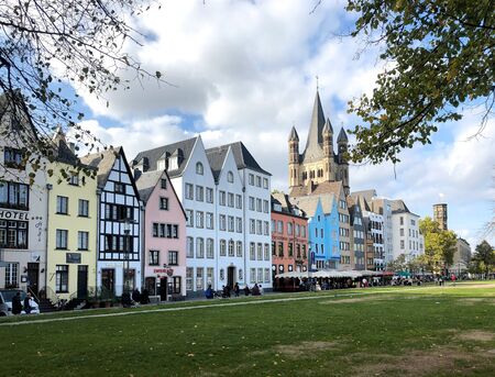 Germany, Cologne - October 2018. Sunny street, multicolored buildings, cozy cafes, city lifeのeditorial素材
