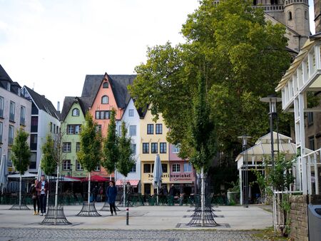 Germany, Cologne - October 2018. Sunny street, multicolored buildings, cozy cafes, city lifeのeditorial素材