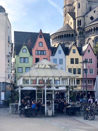 Germany, Cologne - October 2018. Sunny street, multicolored buildings, cozy cafes, city lifeのeditorial素材